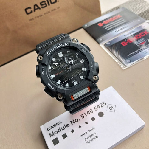 Casio G-Shock wristwatch with black resin case, orange accents, and dark textured strap