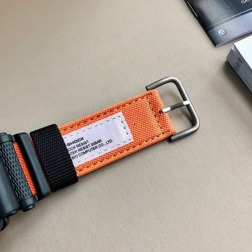 G-Shock wristwatch strap with orange fabric webbing and black metal buckle