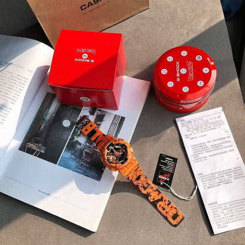 Orange Casio watch with round face, gold accents, and graffiti resin strap