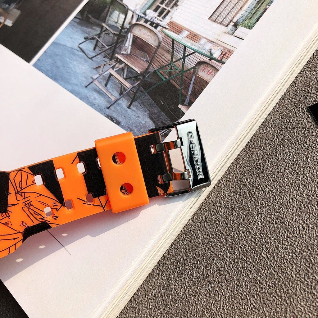 Orange Casio watch strap with metal buckle, showing graffiti pattern and studs
