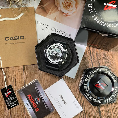 Casio G-Shock digital wristwatch with black bezel and white dial accents, in box