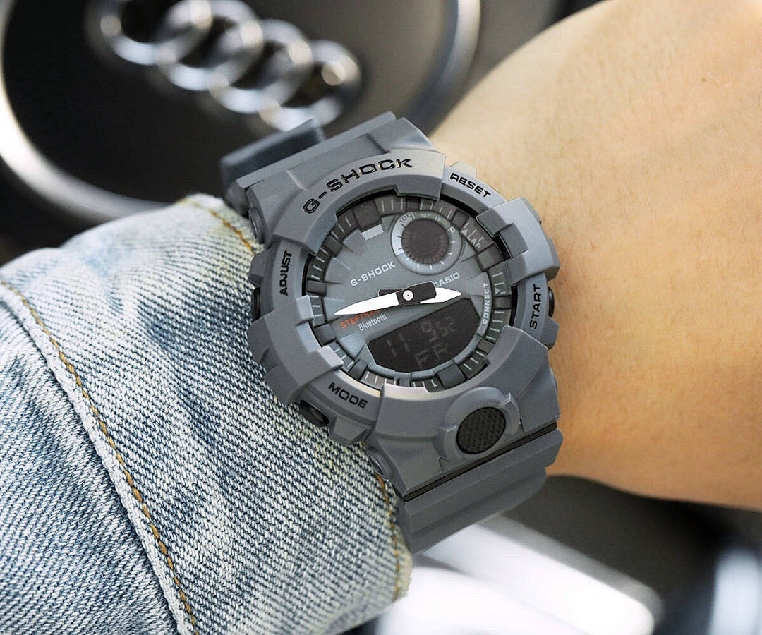 Casio G-Shock gray resin watch with round digital display and textured bezel