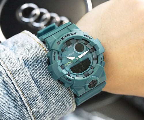 Casio G-Shock teal resin watch with round digital display and textured bezel