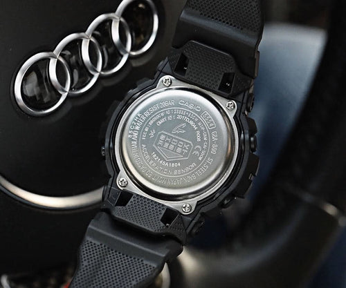 Casio G-Shock black resin watch with visible case back and metal ring detail