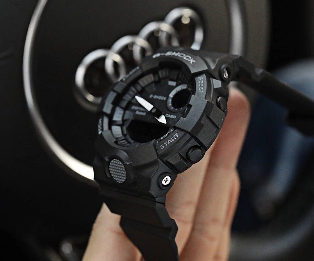 Casio G-Shock black resin watch on wrist with multi-dial face and side buttons