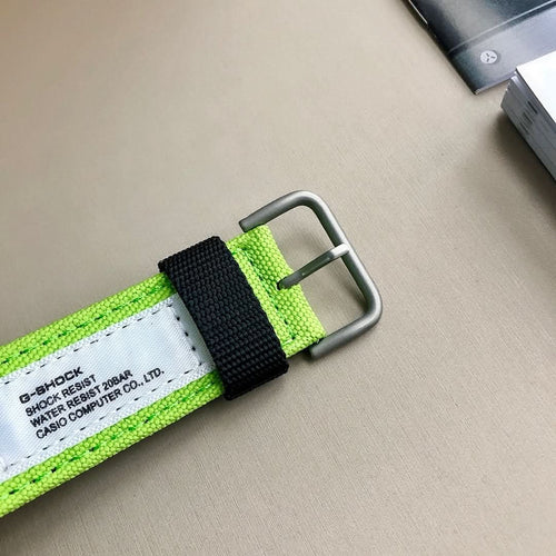 Casio G-Shock watch strap with lime green webbing and metal buckle, black keeper