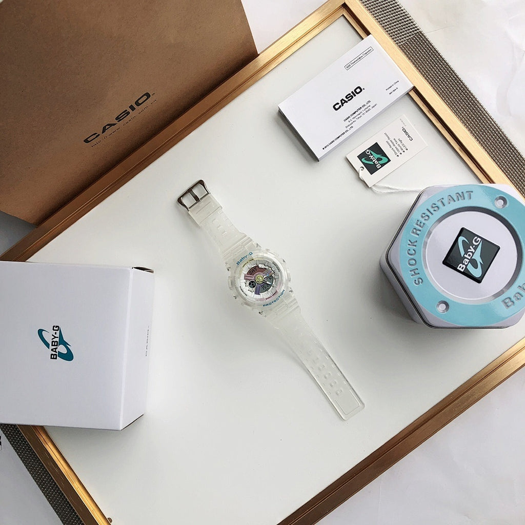Casio wristwatch set with watch, box, and instruction cards on a light tray