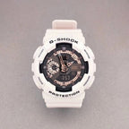G-Shock wristwatch with white resin case, black dial, and pale pink strap