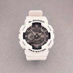 G-Shock wristwatch with white resin case, dark dial with LCD, and pale pink strap