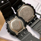 Back of two G-Shock watches showing metal case covers on black resin straps