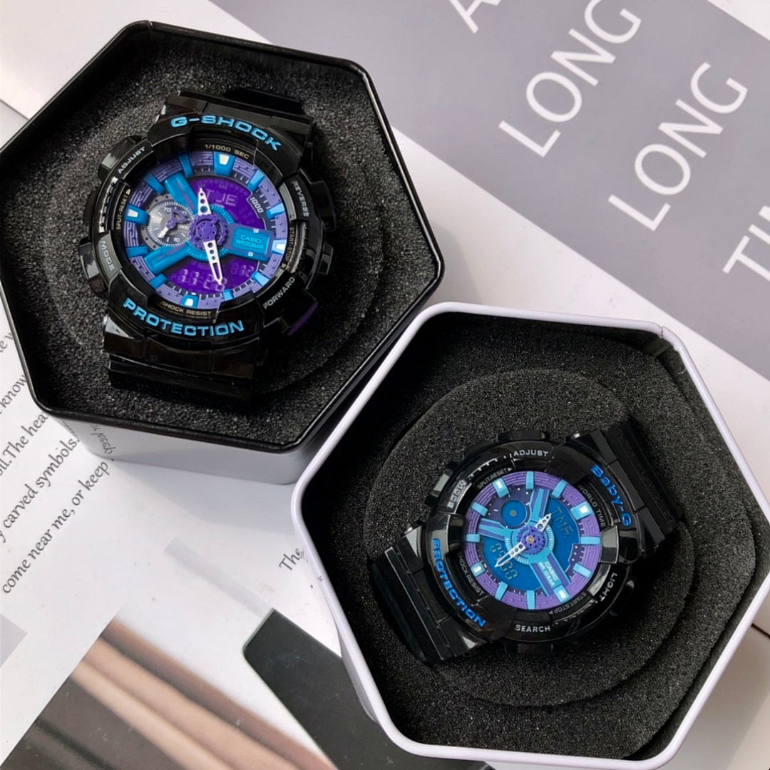 Two G-Shock watches in foam inserts, black cases with blue and purple dial displays