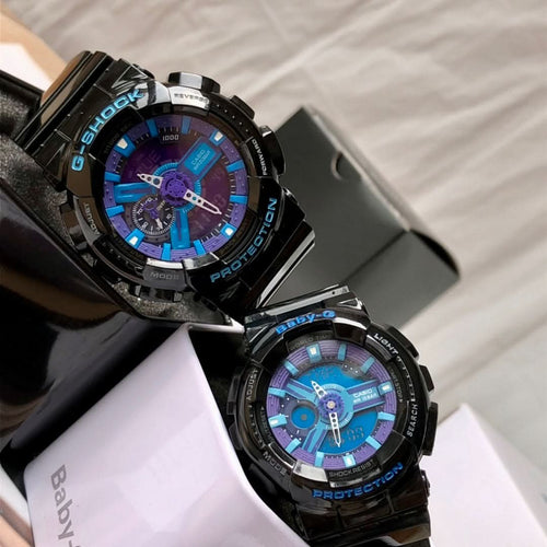 Black G-Shock watch pair in resin cases, blue and purple dials with metal hands