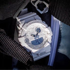 Casio watch with white resin case and black bezel, digital face on fabric strap