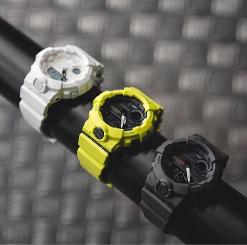 Casio watch trio: bright yellow and black and white watches on black bands