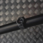 Casio watch with black strap and round digital face on a dark bar