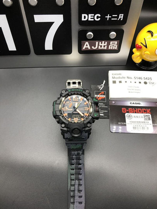 Casio watch with black case, orange dial, and green patterned strap