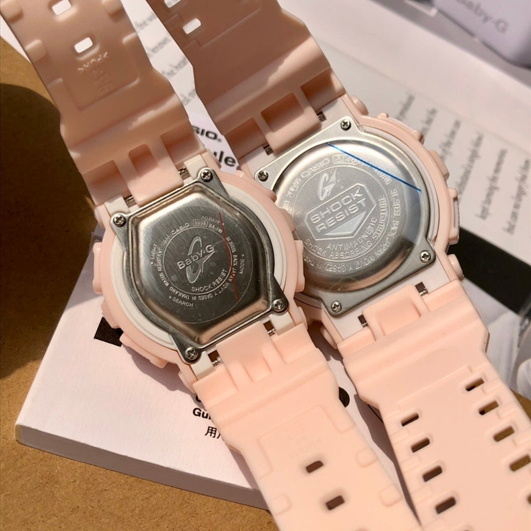 Close-up of light pink resin watch backs with engraved case plates and screws