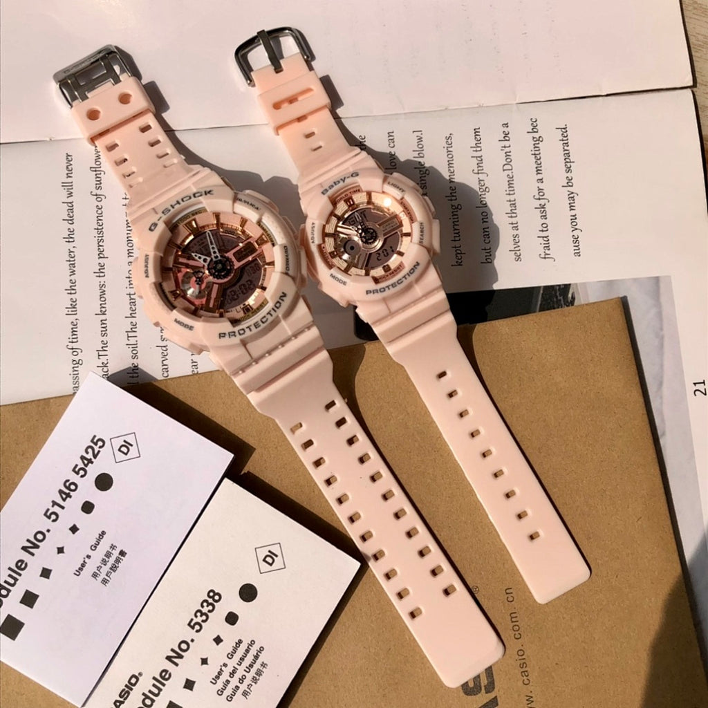 Two light pink resin wristwatches on packaging cards, showing straps and round cases