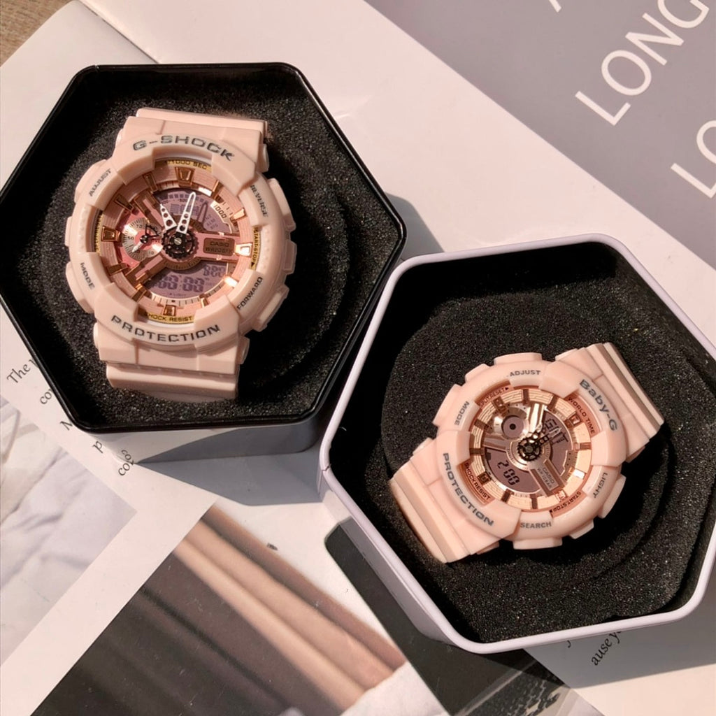 Two wristwatches in open cases with light pink resin straps and round multi-dial faces