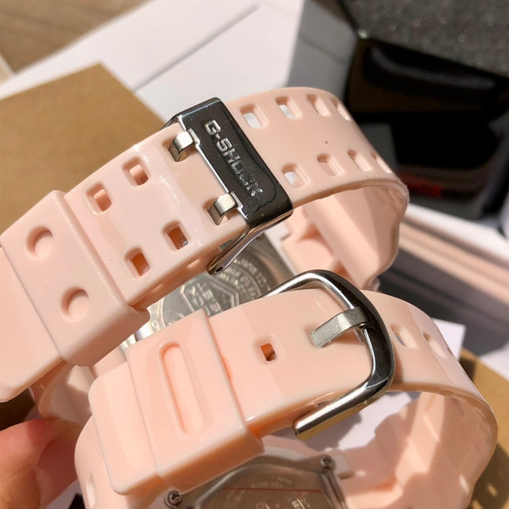 Light pink resin watch straps with metal buckle and part of the round case visible