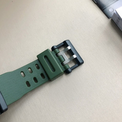 Casio G-Shock wristwatch strap closeup with green perforated resin and metal clasp