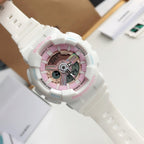 Casio white wristwatch with pink center dial and digital display windows