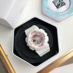 Casio white resin watch with pink dial and round bezel, resting in a box