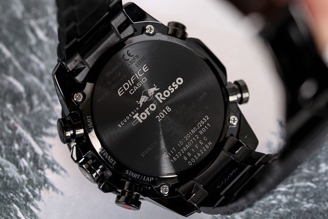 Casio watch case back with engraved text, black steel bracelet
