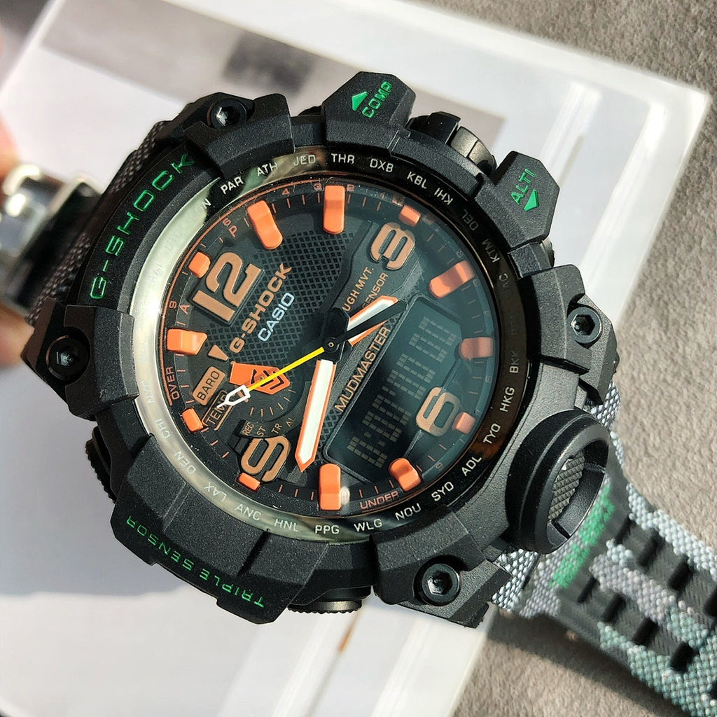 G-Shock style digital watch with black case, orange markers, textured black rubber strap