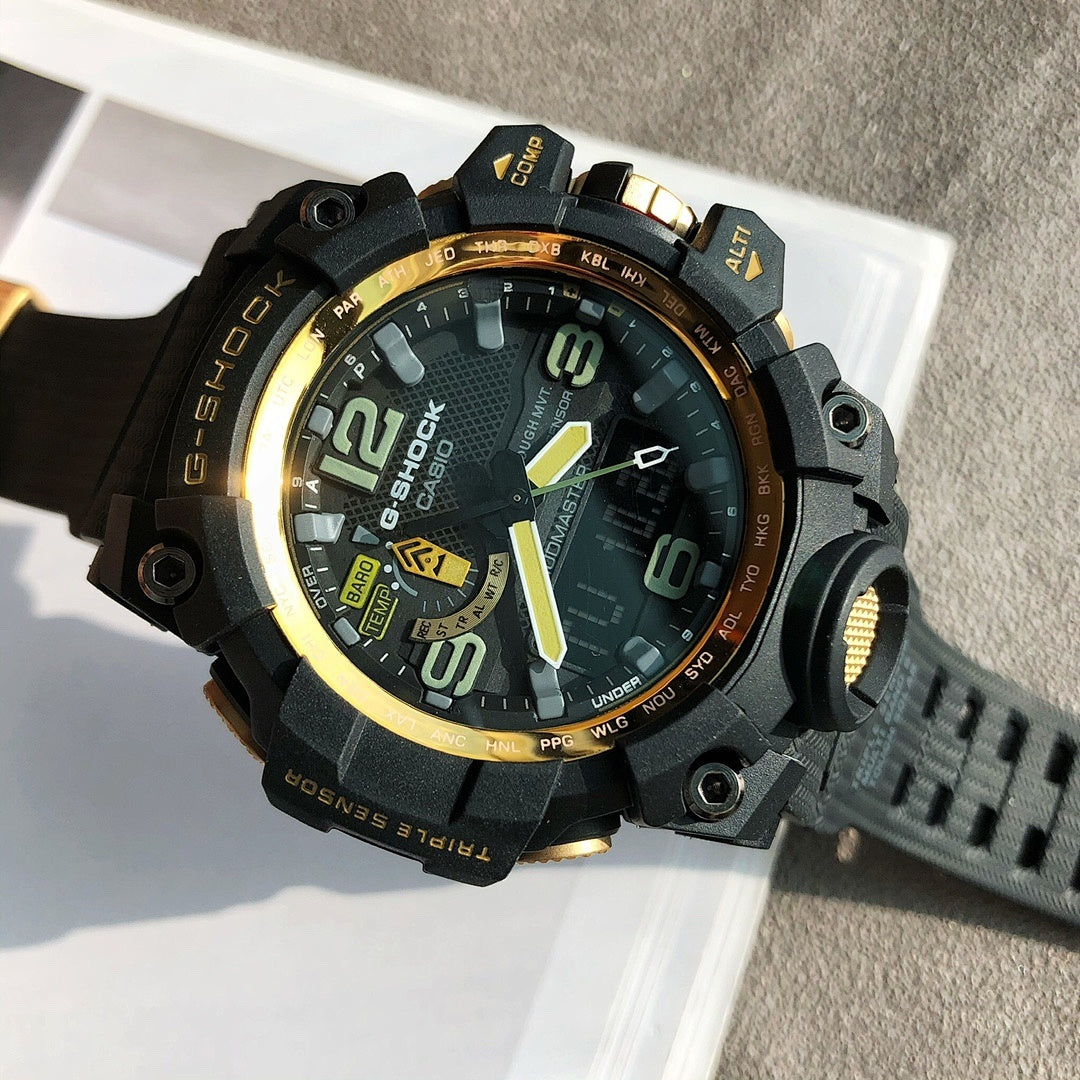 G-Shock style digital watch with gold-trim bezel, black case, dark green rubber strap