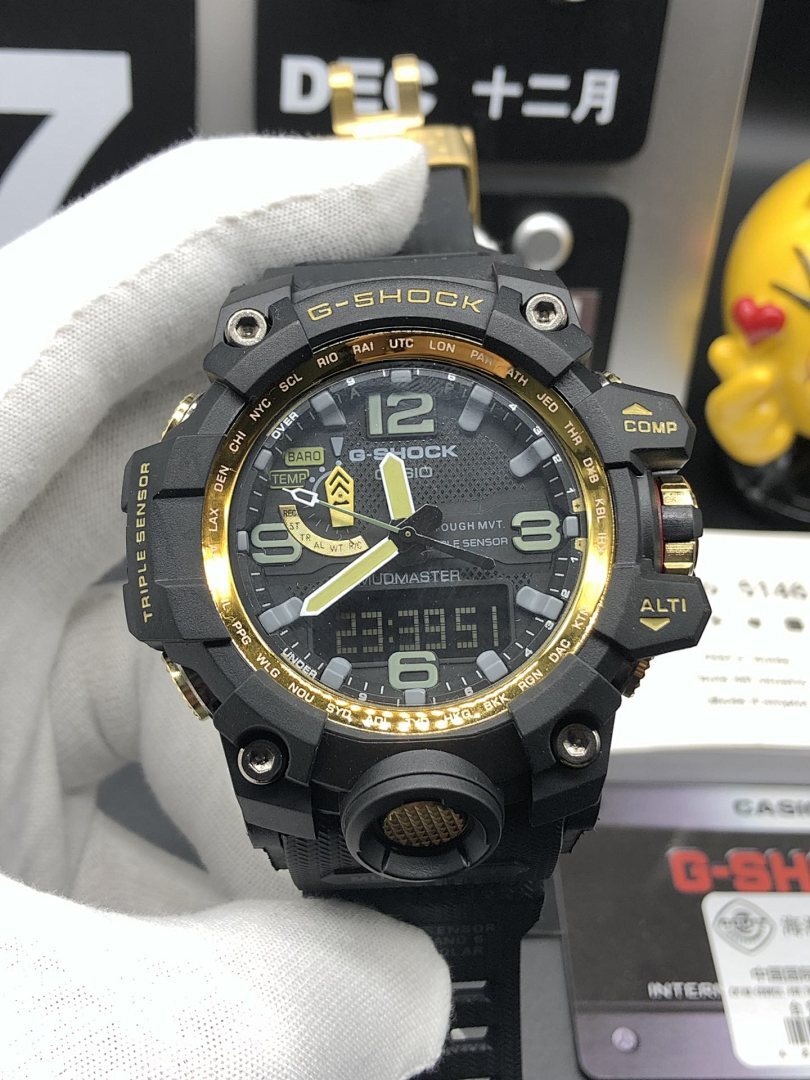 Casio G-Shock wristwatch front view with black bezel, gold accents, and green markers