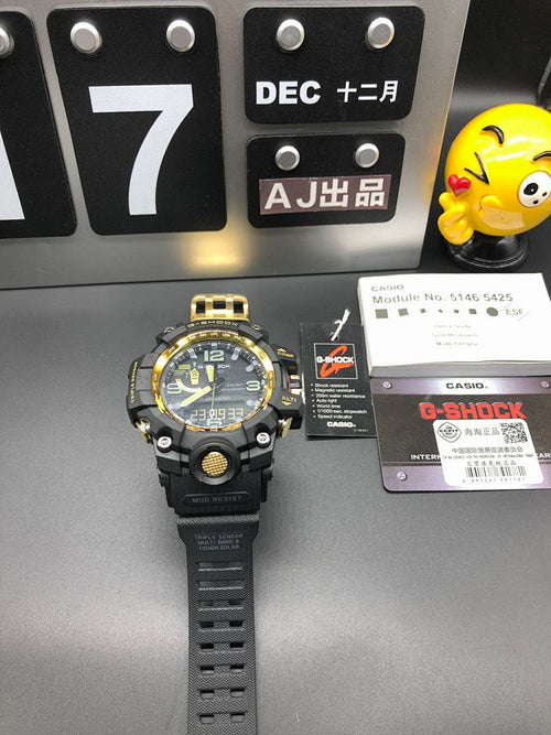 Casio G-Shock wristwatch on black strap with gold bezel highlights and dark dial