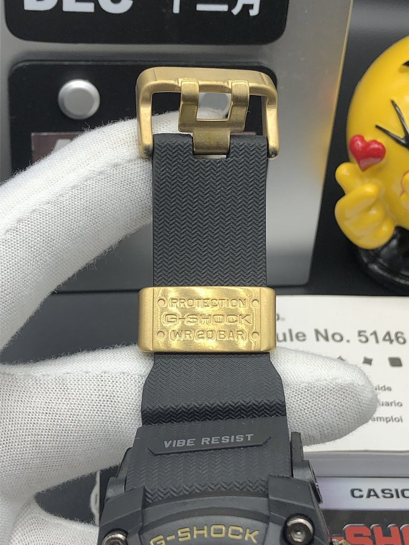Casio G-Shock wristwatch buckle clasp in gold tone on black textured strap