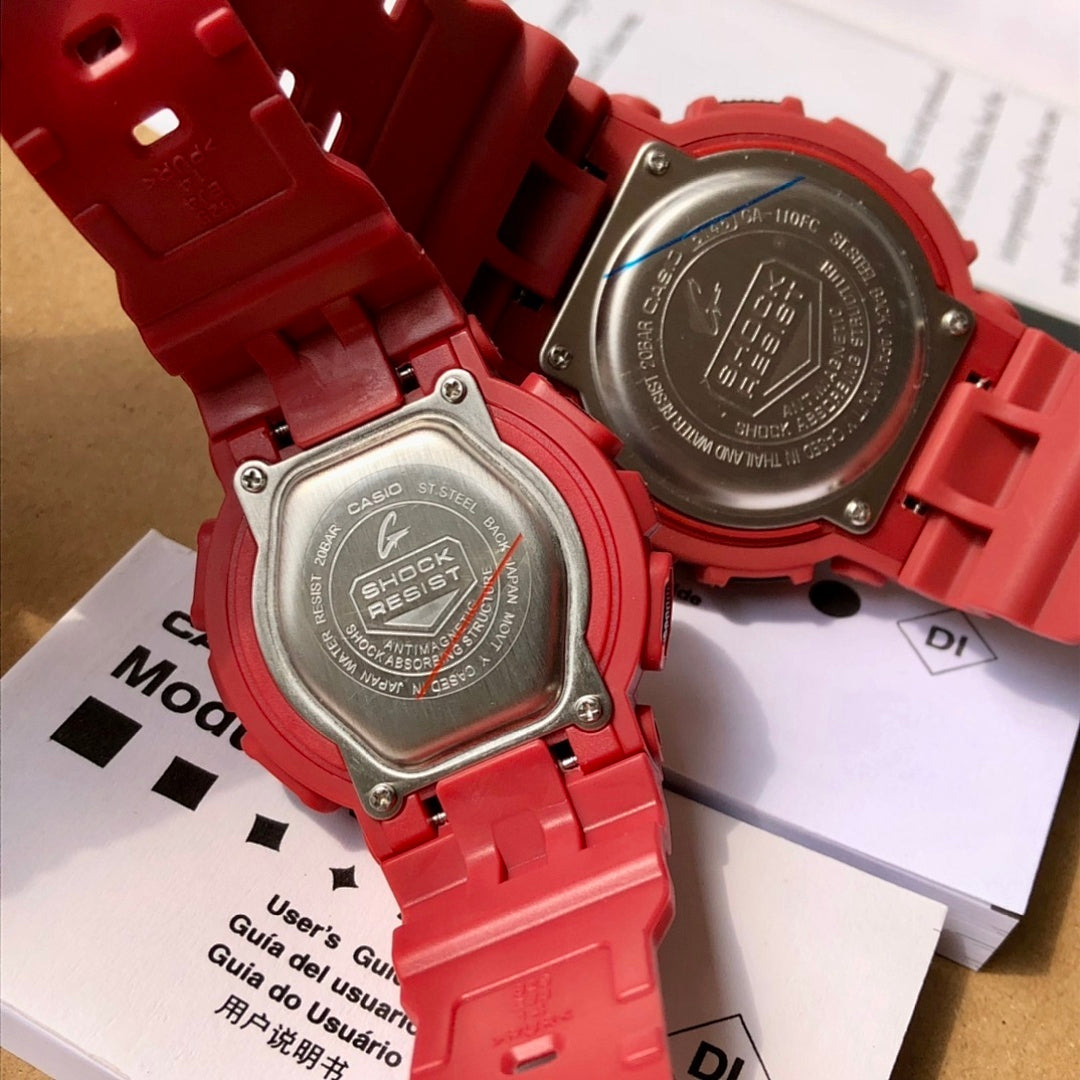 Two red Casio watches showing backs with metal cases and embossed markings
