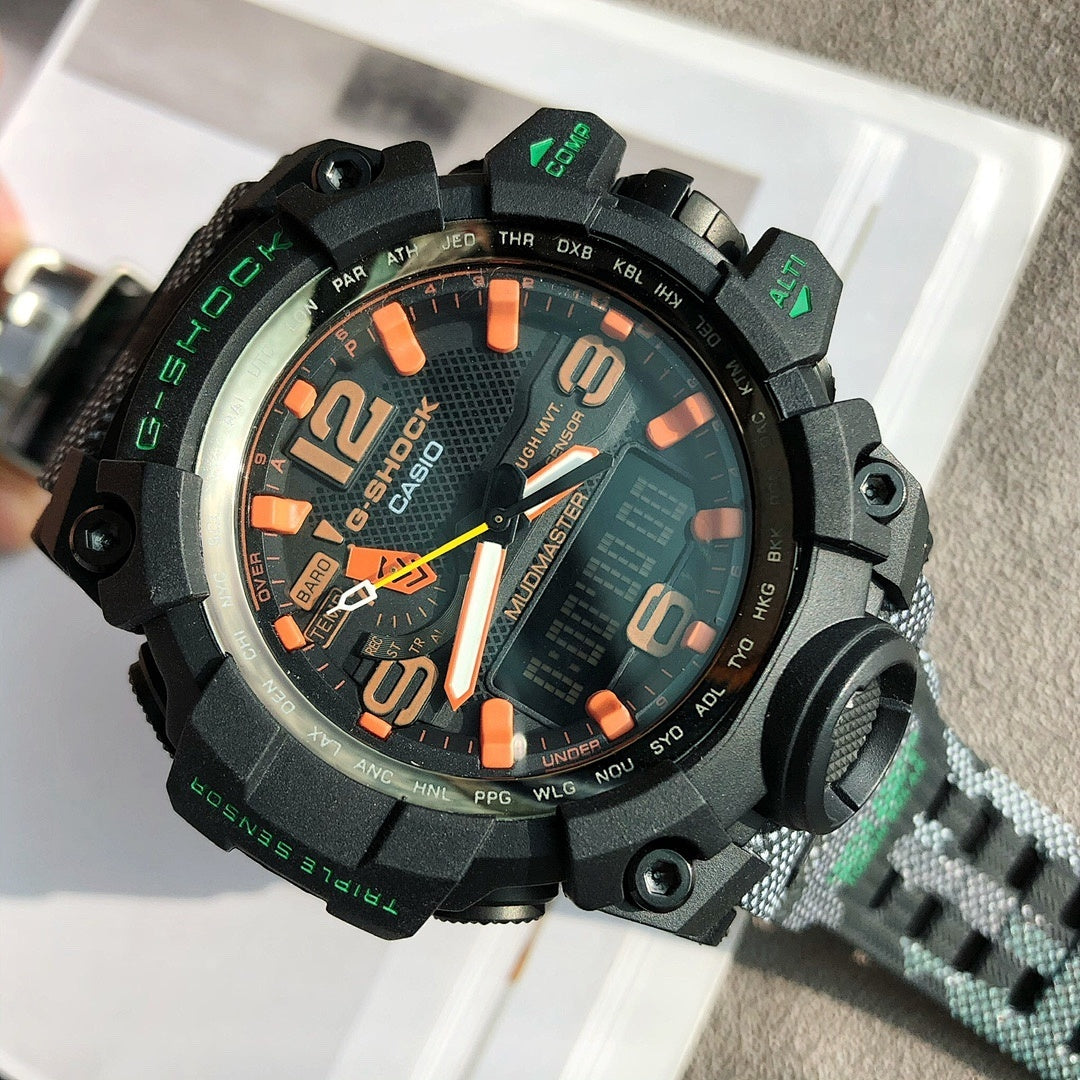 G-Shock digital watch with black case, orange dial markers, and green accent details