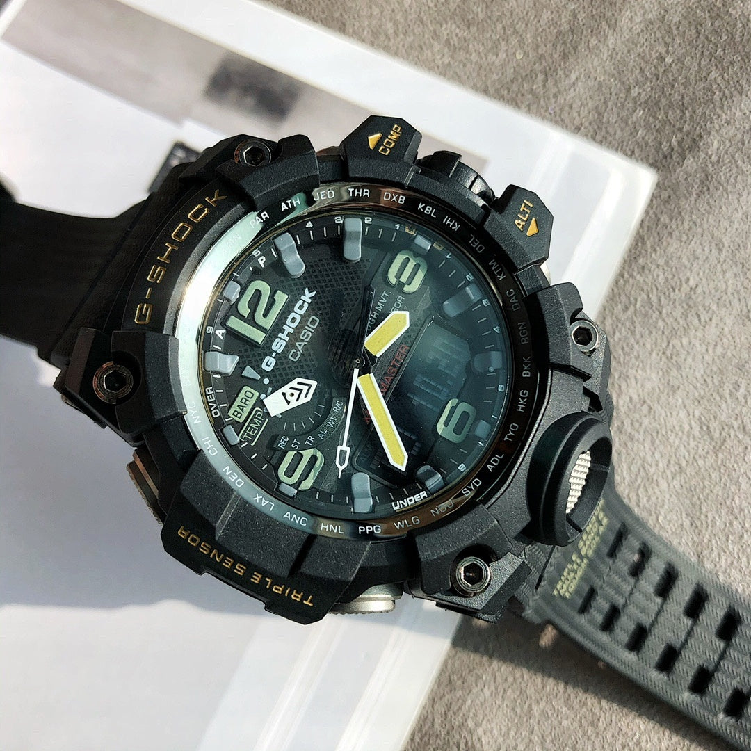 G-Shock digital watch with black case, yellow hand accents, and dark green dial
