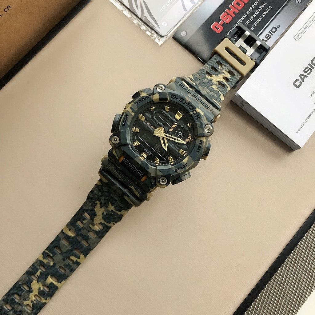 G-SHOCK digital sports watch with camo strap and beige buckle facing upward