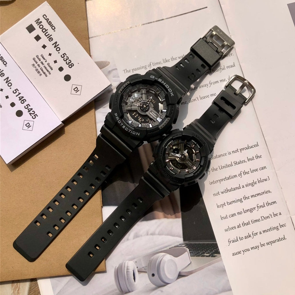 Two black resin Casio watches with metal buckles and perforated straps