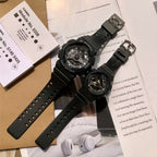 Two black resin Casio watches with metal buckles and perforated straps