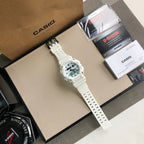 White G-SHOCK watch laid diagonally with perforated strap and round digital face