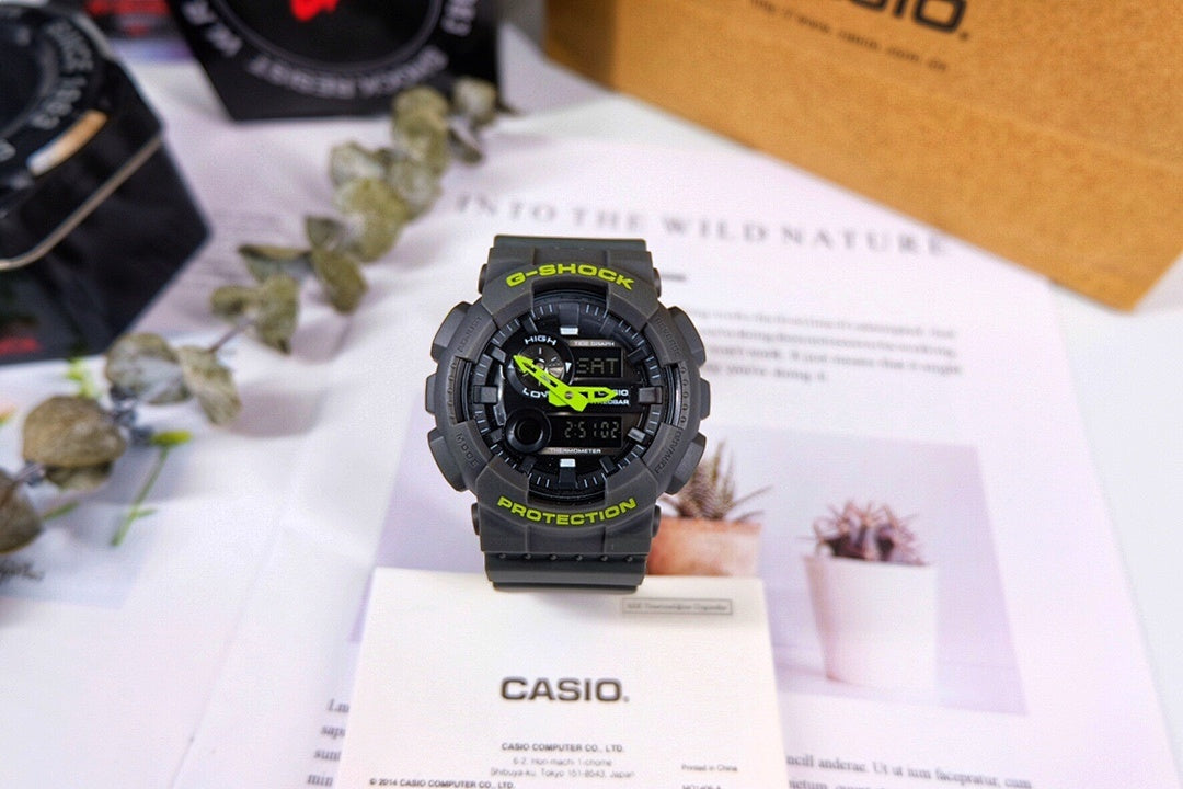 Casio G-Shock watch with black resin strap and green digital accents