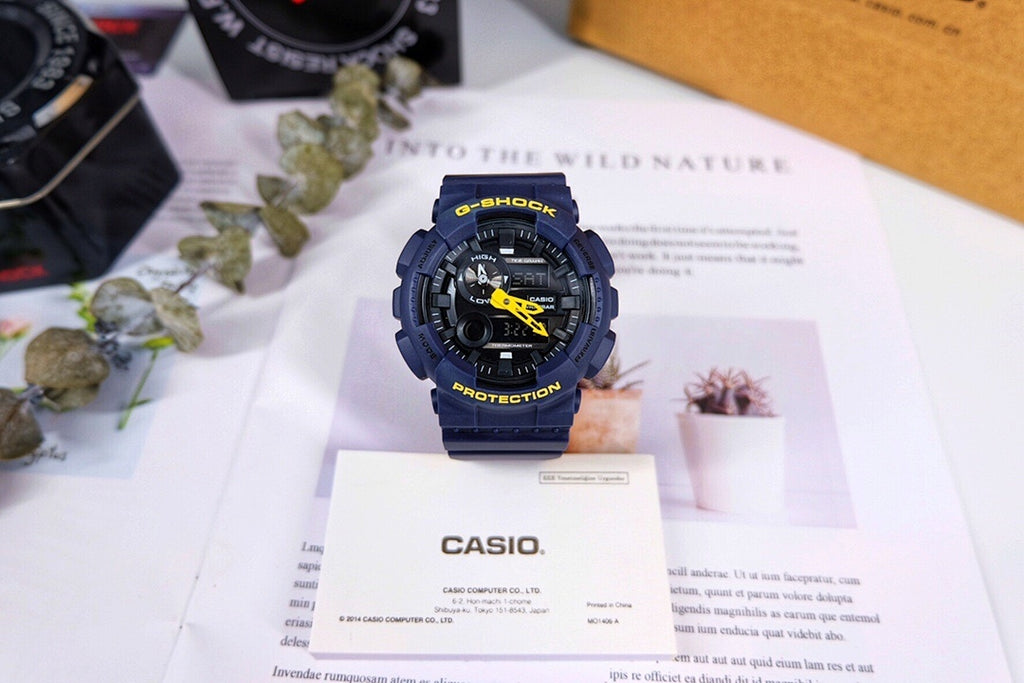 Casio G-Shock watch with dark blue strap and yellow digital display