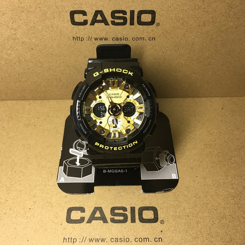 Casio G-Shock watch with black case, gold-tone dial, and digital-style markings.