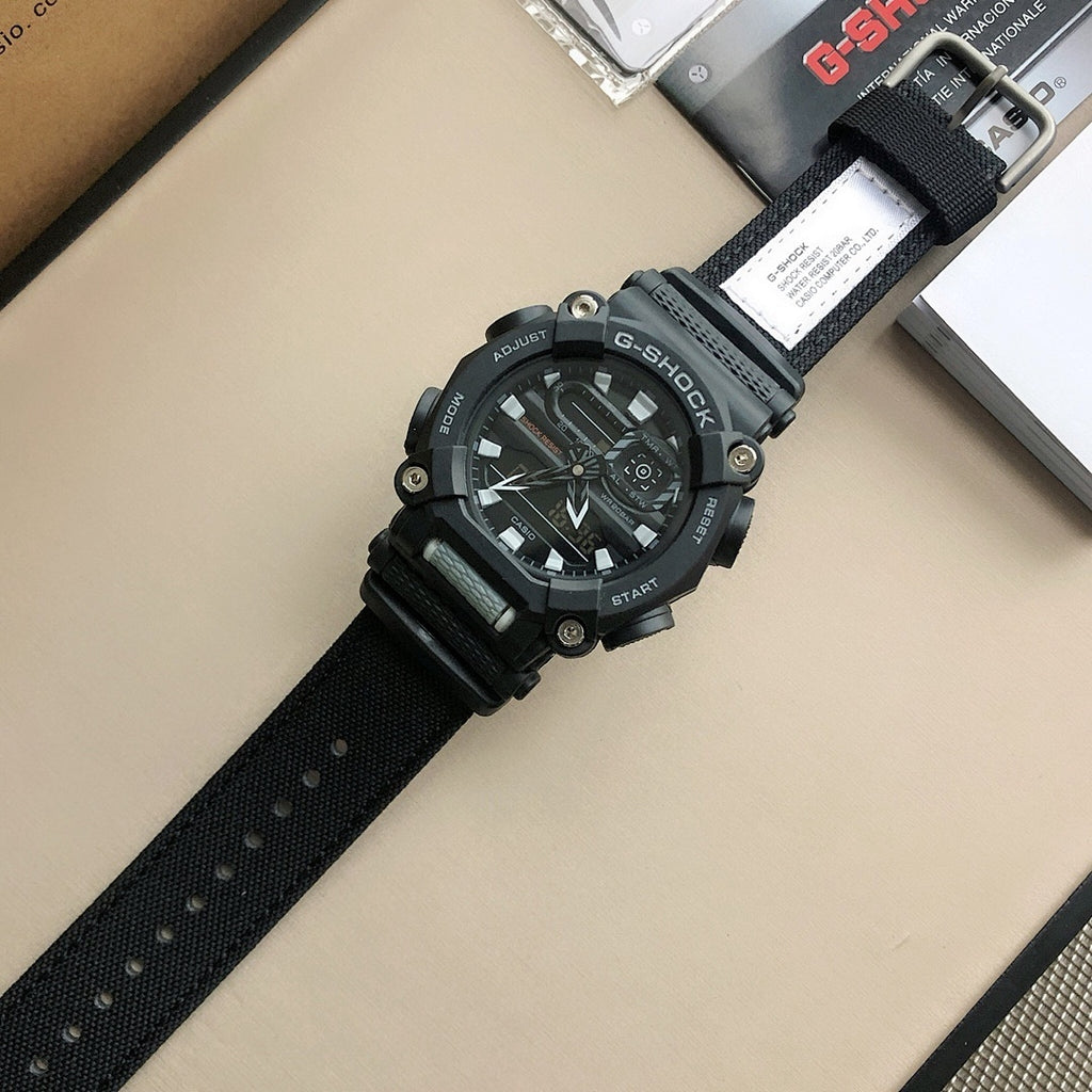 Casio G-Shock wristwatch at angle with black perforated strap and hanging paper tag