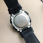 Casio G-Shock watch caseback with embossed shield and silver finish, on black strap