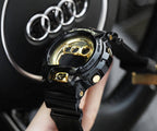 Casio G-Shock watch face with gold dial, black resin strap, and side buttons