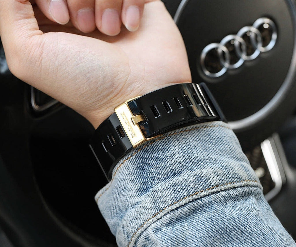 Casio G-Shock watch with black ribbed strap and gold-toned buckle clasp