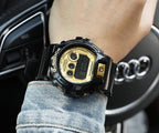 Casio G-Shock digital watch with gold-tone dial and black resin strap