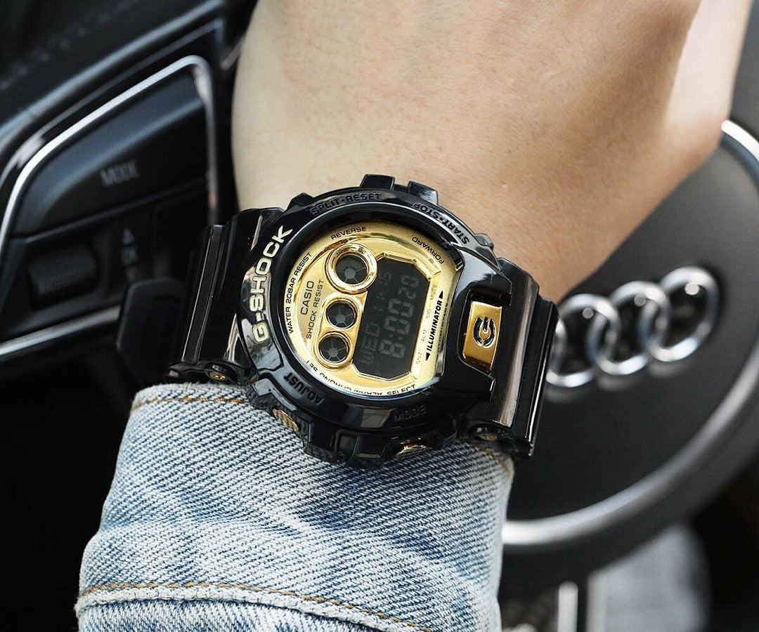 Casio G-Shock digital watch with gold-tone dial and black resin strap