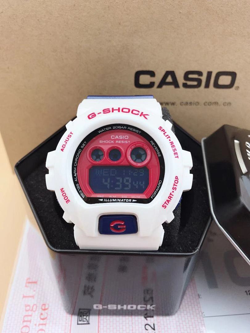 Casio G-Shock digital watch with red LCD screen and white case, black strap
